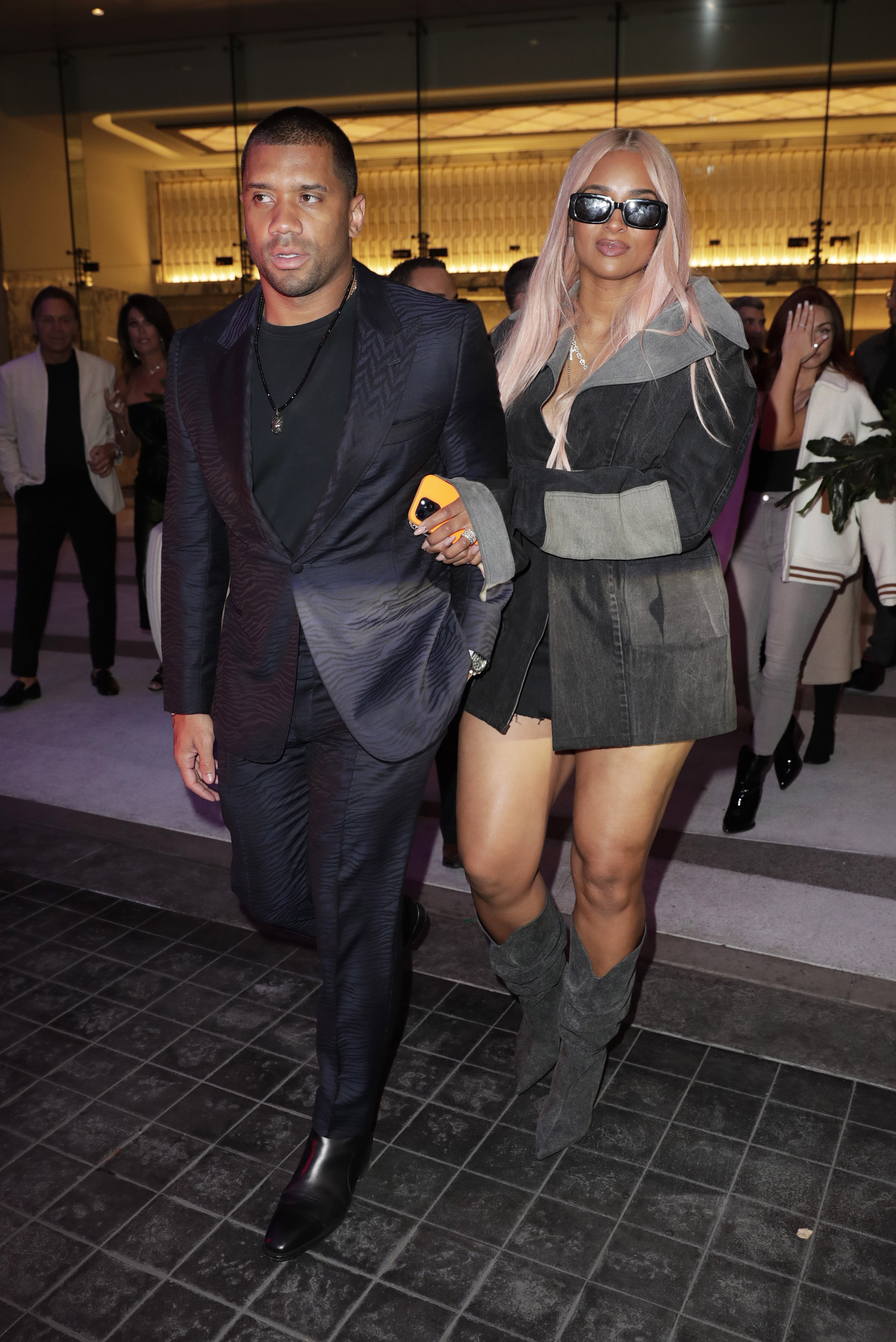 Ciara and her husband Russell Wilson linked arms as they braved the light rain on Friday night and headed to the valet