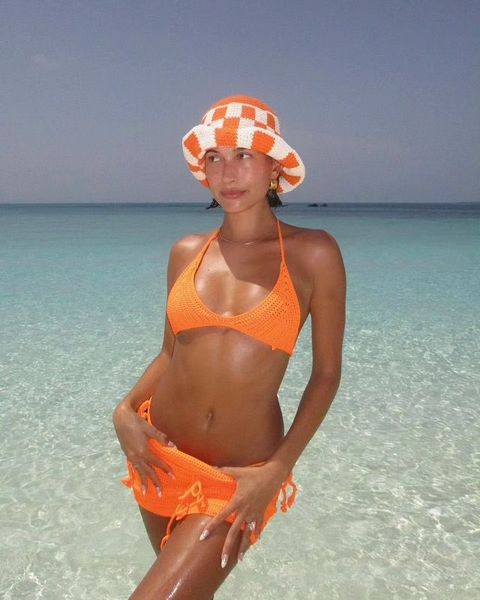 Hailey strikes a pose in this orange ensemble in the water