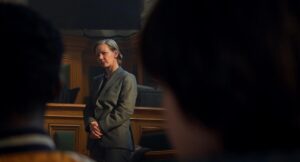 A woman in court is seen between the backs of two people's heads in "Anatomy of a Fall."