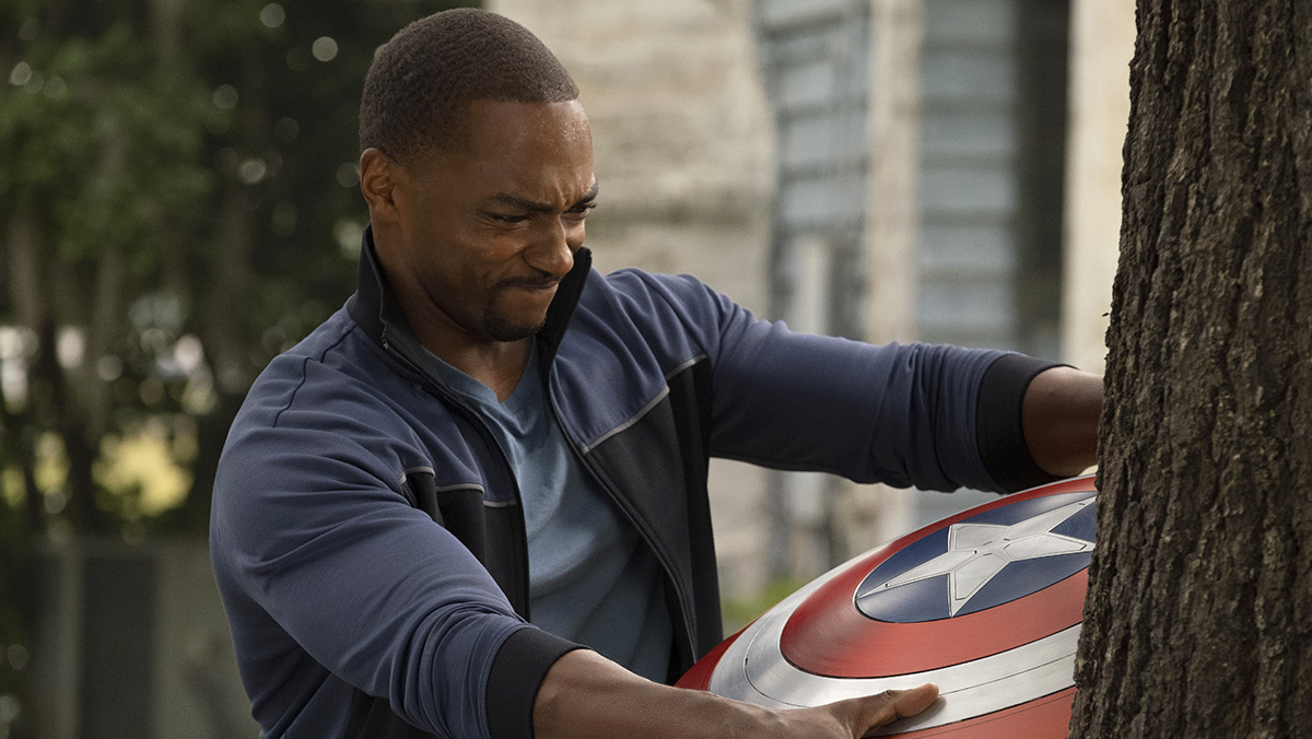 Sam Wilson tries to pull Captain America's shield out of a tree in The Falcon and the Winter Soldier