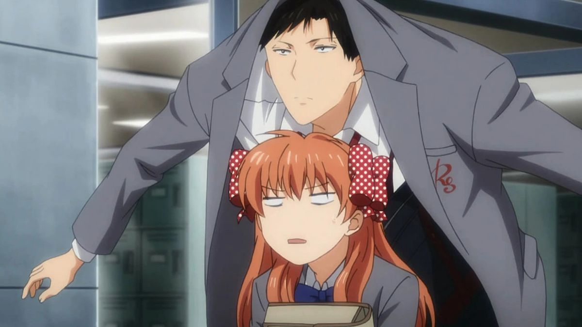 A tall young man with dark hair holds his arms out so that his coat covers a small girl with orange hair in order to shield her from the rain. But he’s stacked over her and positioned so that his jacket also covers his head. He looks very serious, she looks vaguely annoyed.