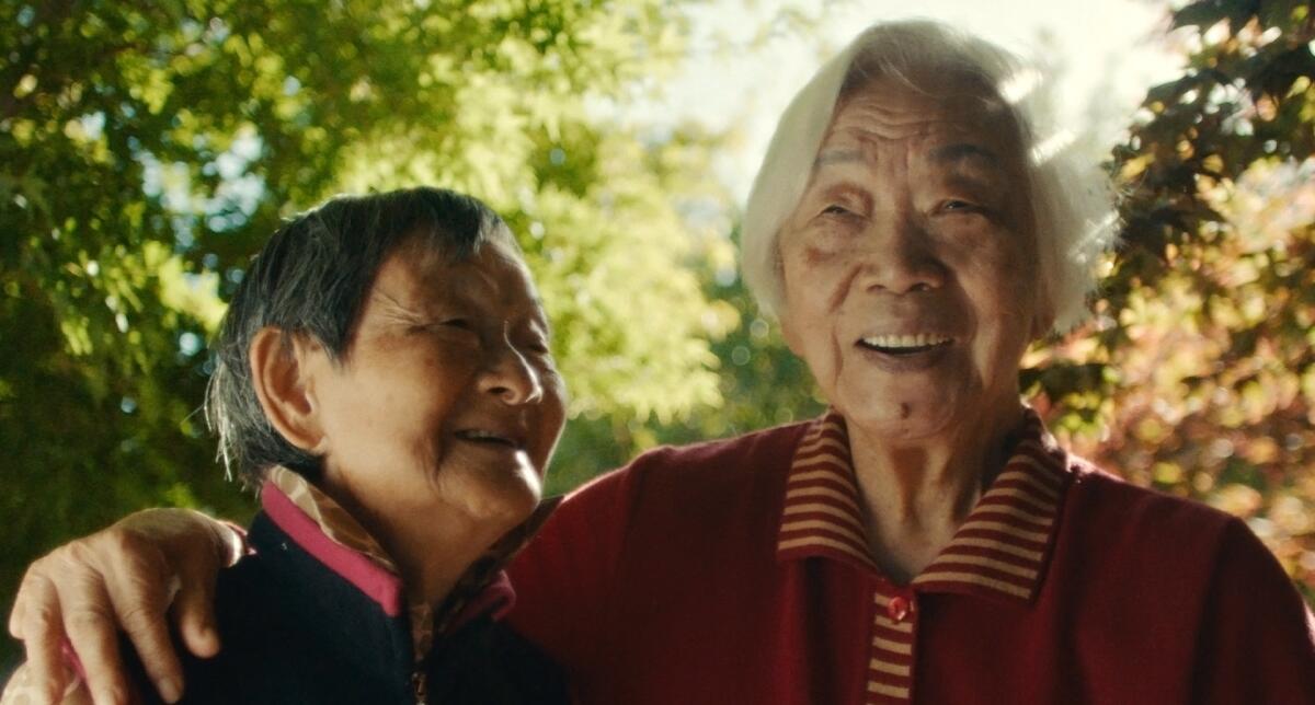 Two grandmothers laugh.