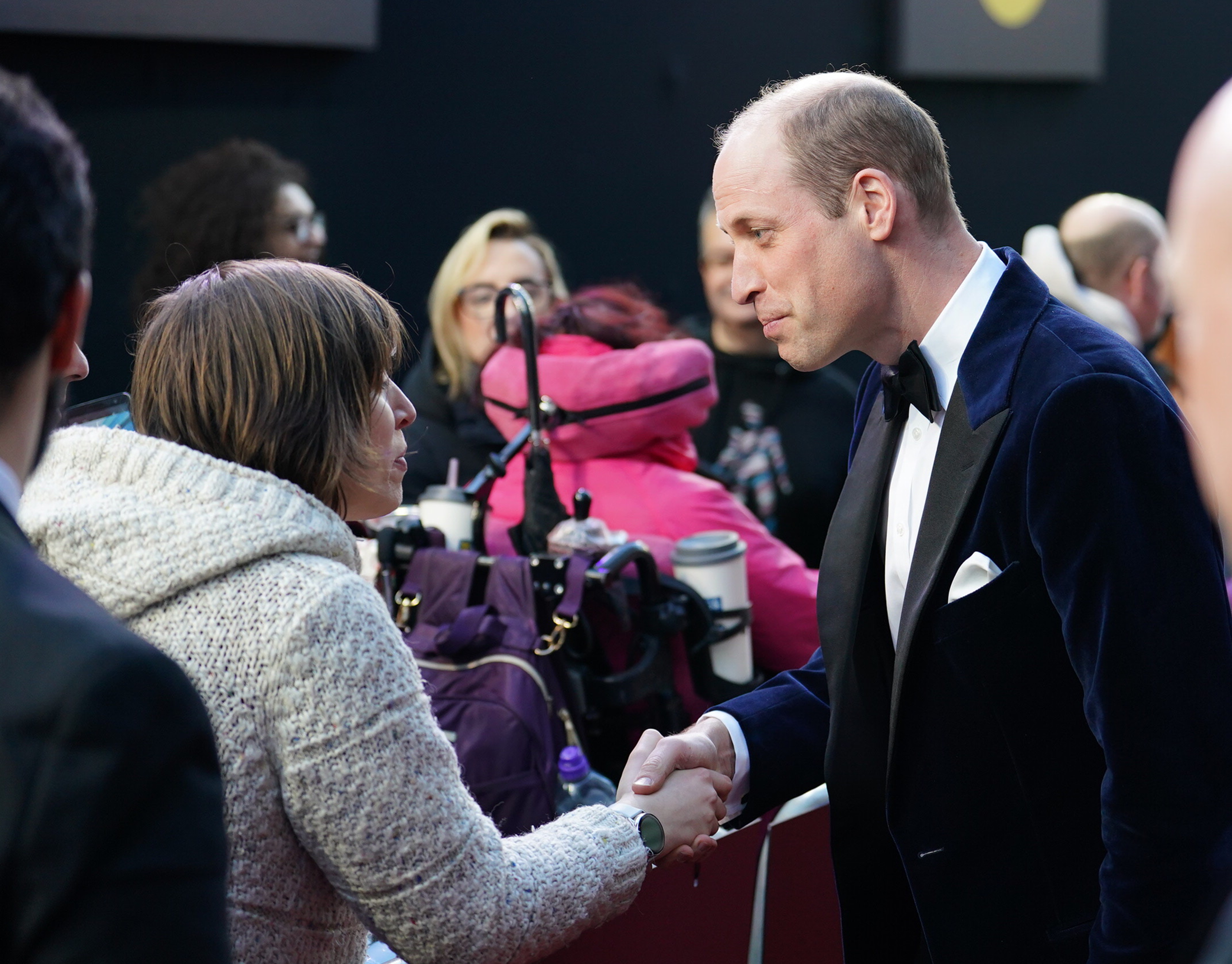 Prince Wiliam, president of Bafta, pauses to meet and greet fans on the red carpet