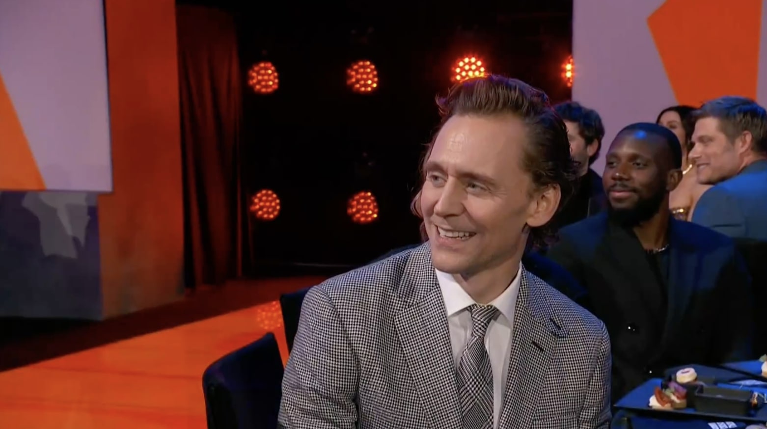 Tom Hiddleston was caught 'cringing' by the cameras as his ex Taylor Swift received praise