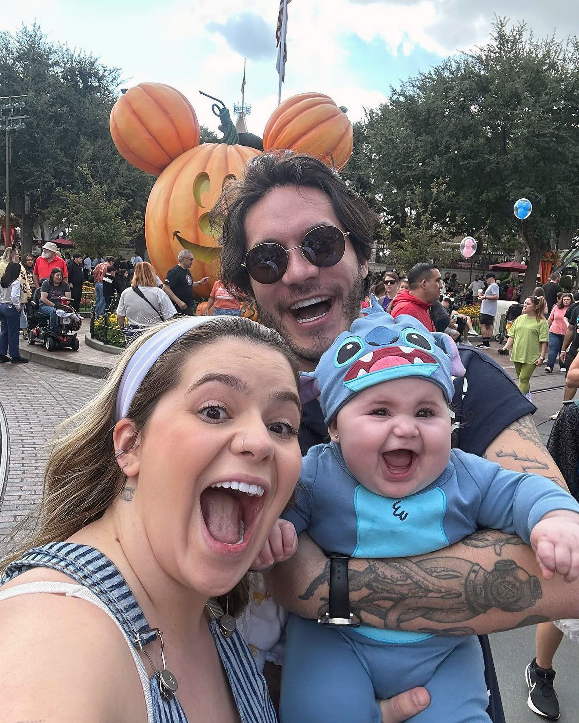 Little Lua with her parents on a trip to Disneyland