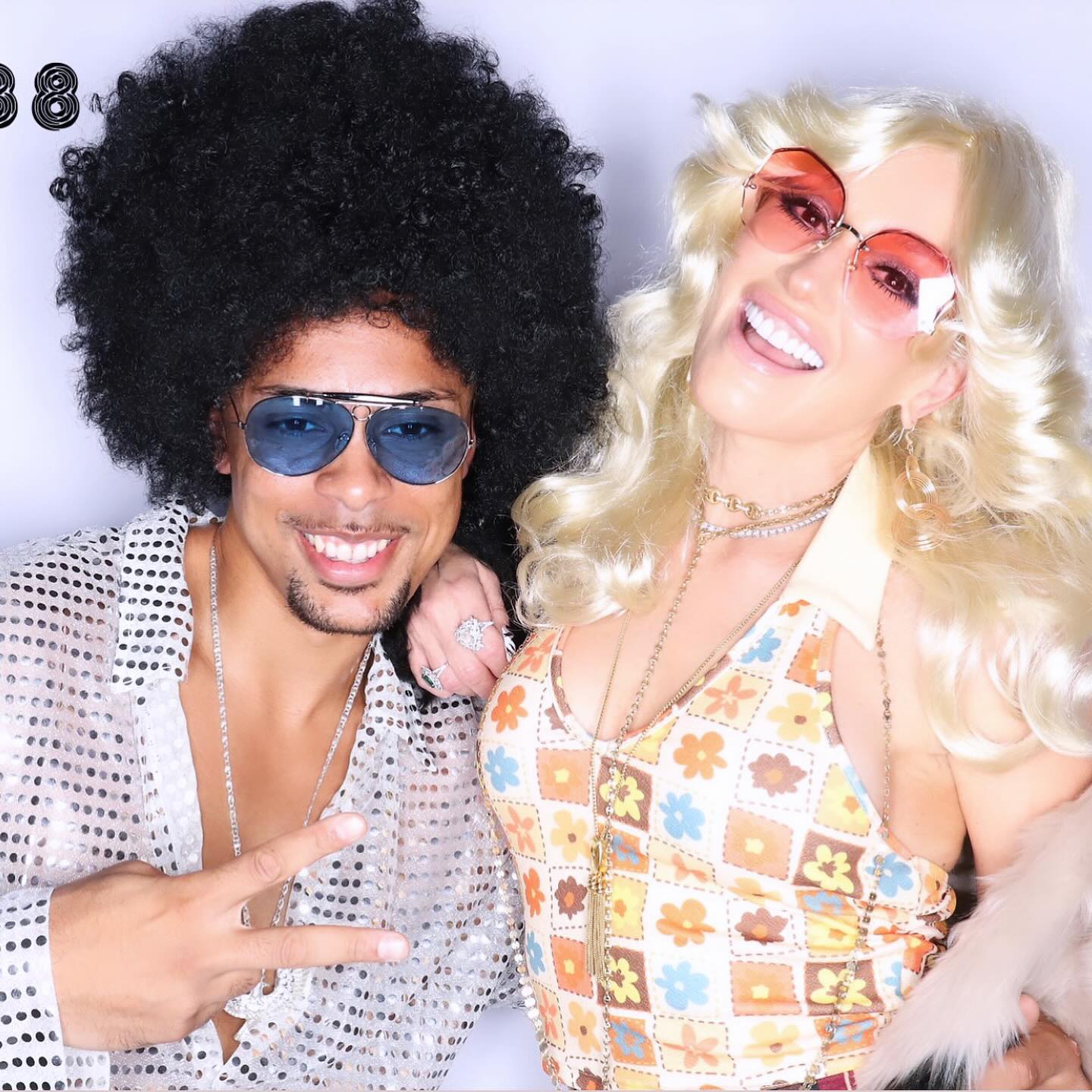 She posed with her trainer Christopher Kadima at a wild 70s-themed birthday party