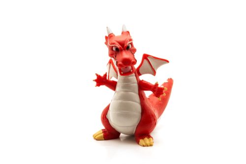Red plastic dragon isolated on white background