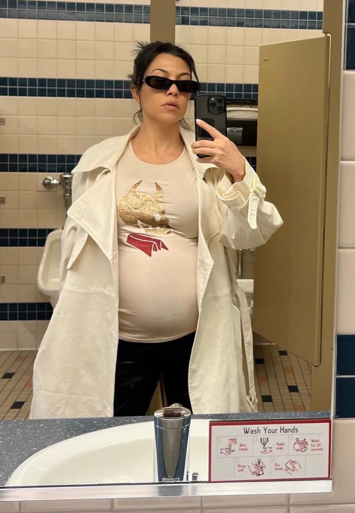 In July, a very pregnant Kourtney shared another mirror selfie in front of a toilet and urinal
