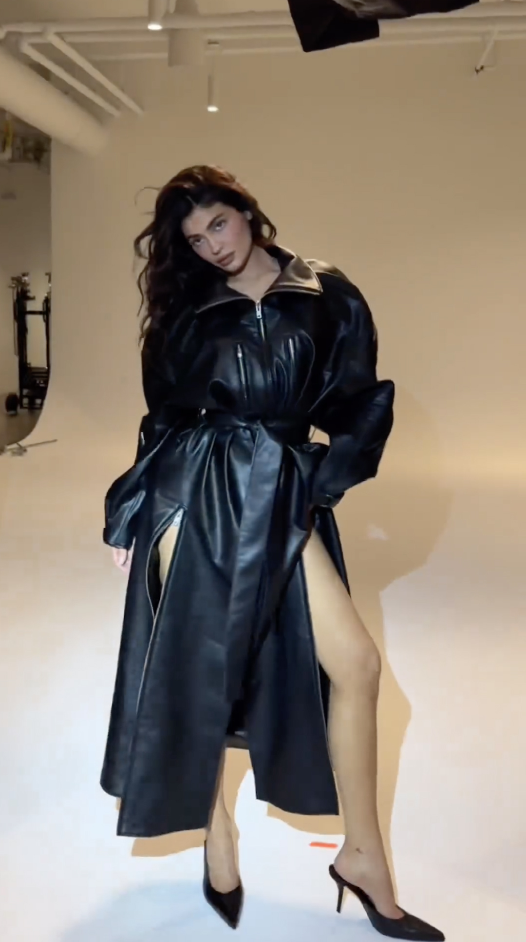 The Kardashians star shared a video of herself modeling the trench coat on Instagram