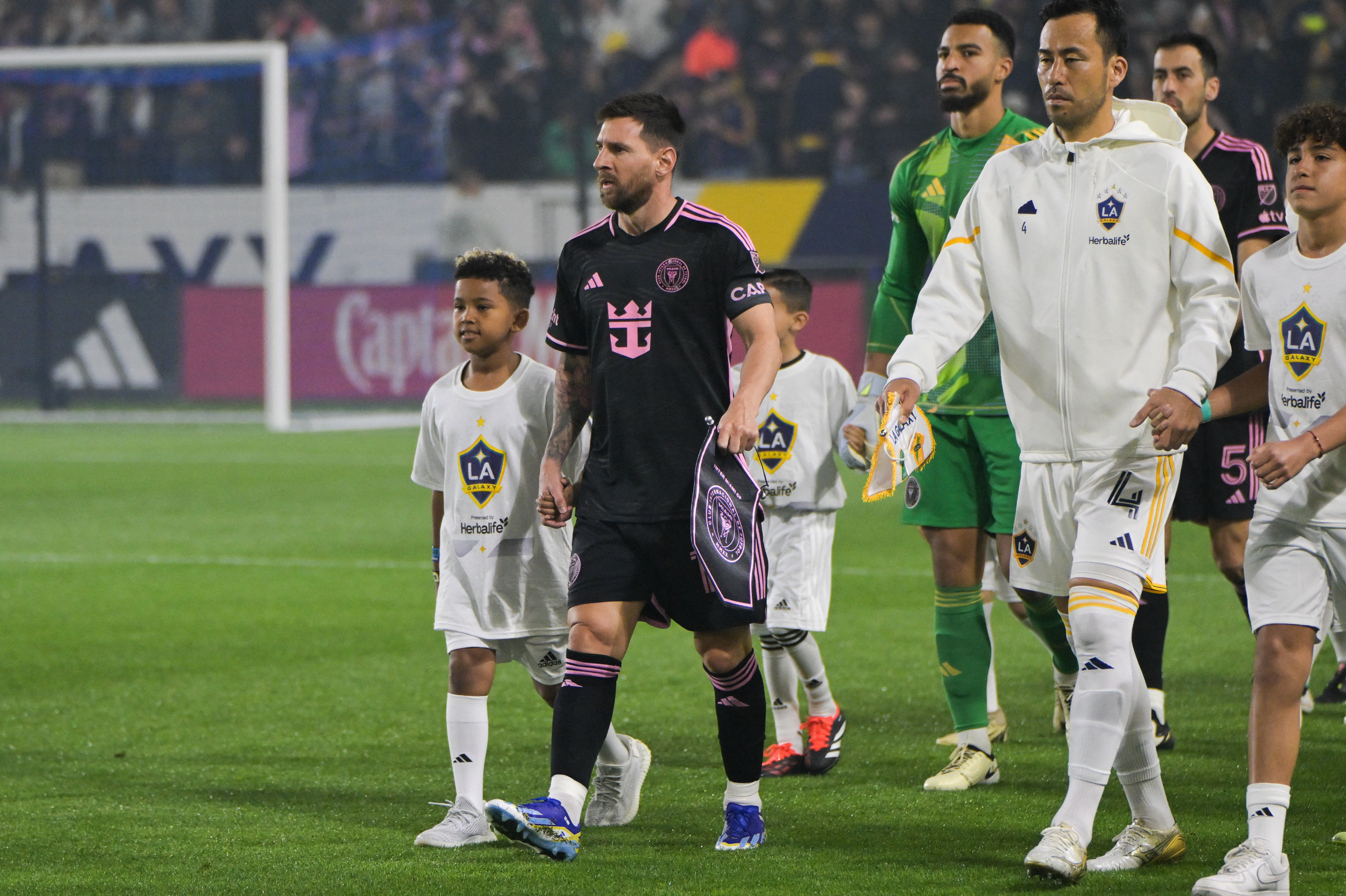 Saint West held hands with Lionel Messi as they walked out onto the field