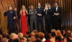 Kenneth Branagh and the cast of "Oppenheimer" onstage after winning the SAG Award for motion picture ensemble.