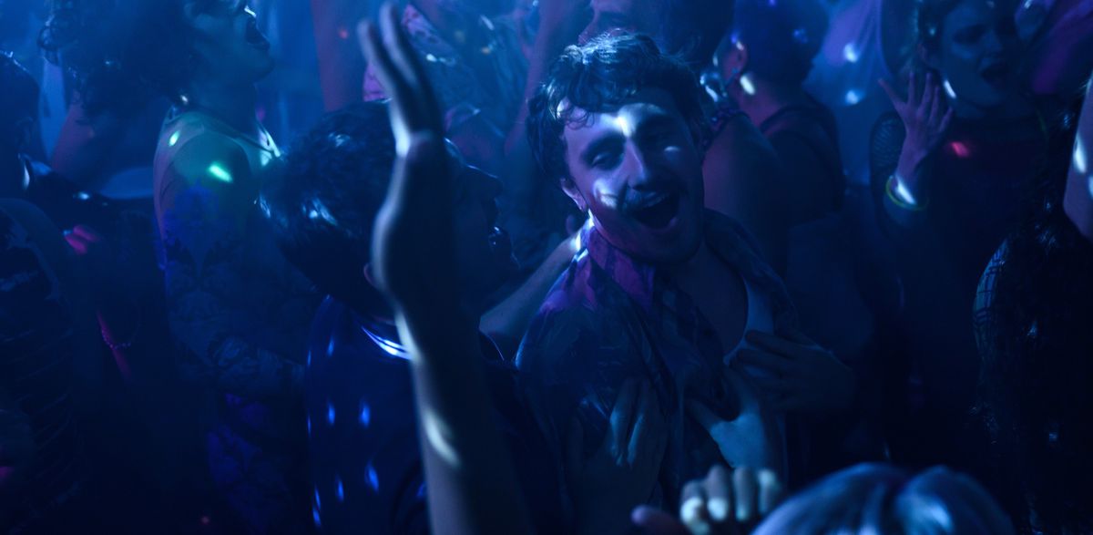 Adam (Andrew Scott) and Harry (Paul Mescal) dance together in a nightclub in purple spangled light in All of Us Strangers