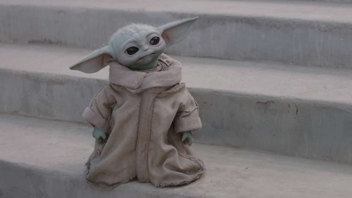 Grogu standing in his robe on marble steps on The Mandalorian