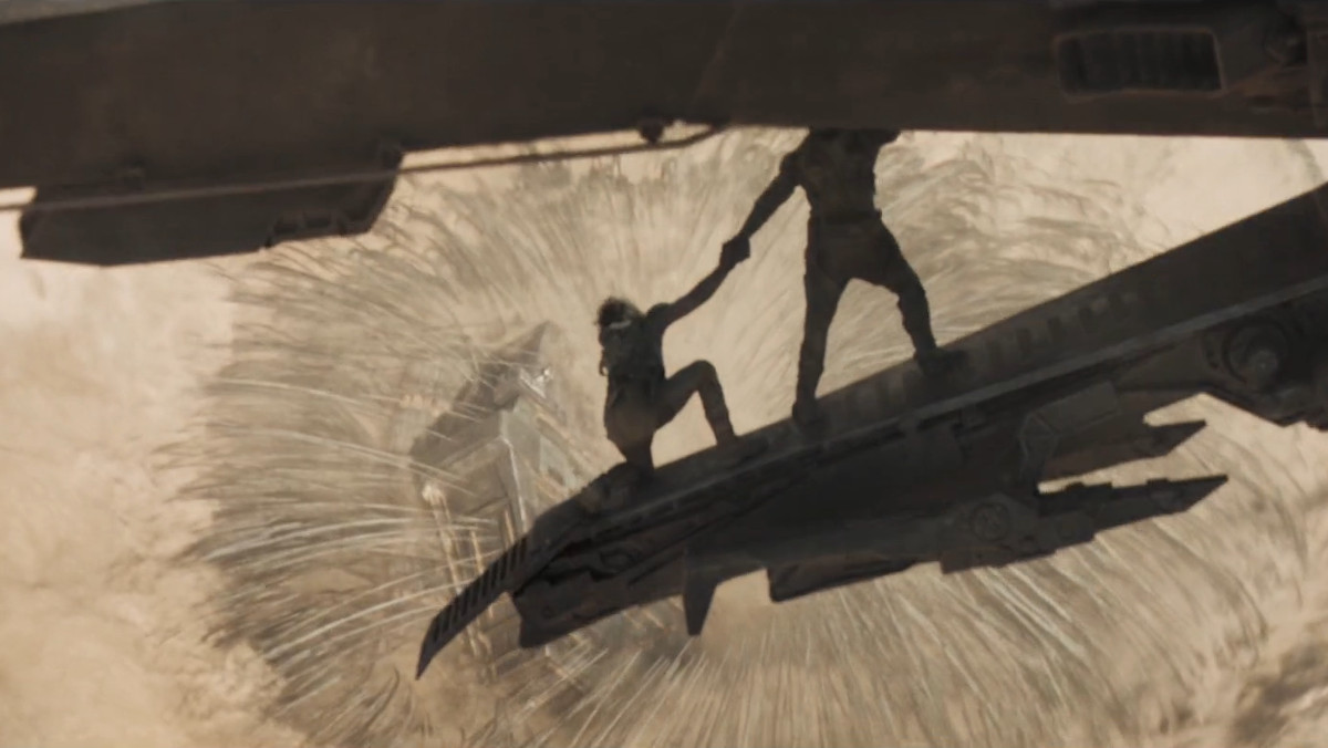 Two characters leaning out of an ornithopter in the Dune trailer