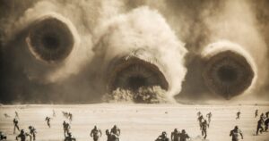 Sandworms on Arrakis emerge from a storm in Dune: Part Two with soldiers in front of them