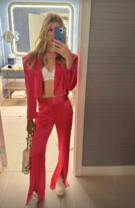 Bouchard posed in an open suit and showed off her white bra