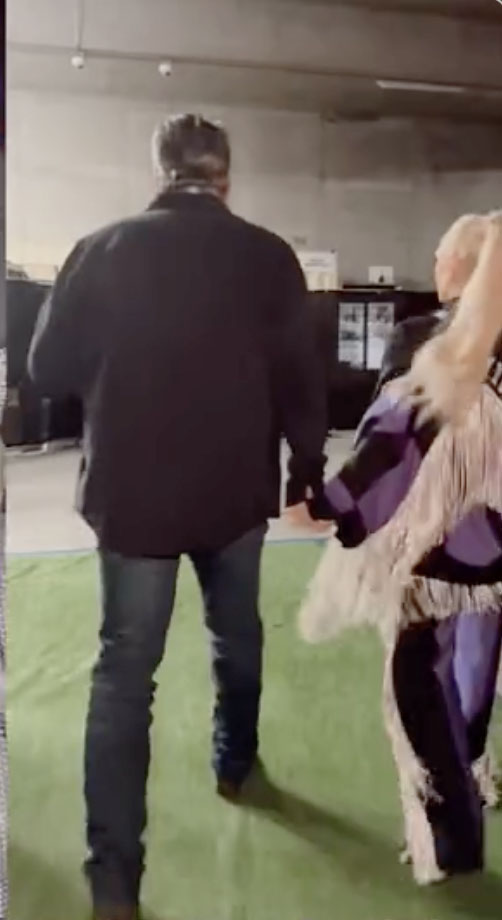 Gwen Stefani holds her husband Blake Shelton's hand before going on stage