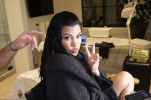 Kourtney Kardashian teased bare legs while wearing a black robe