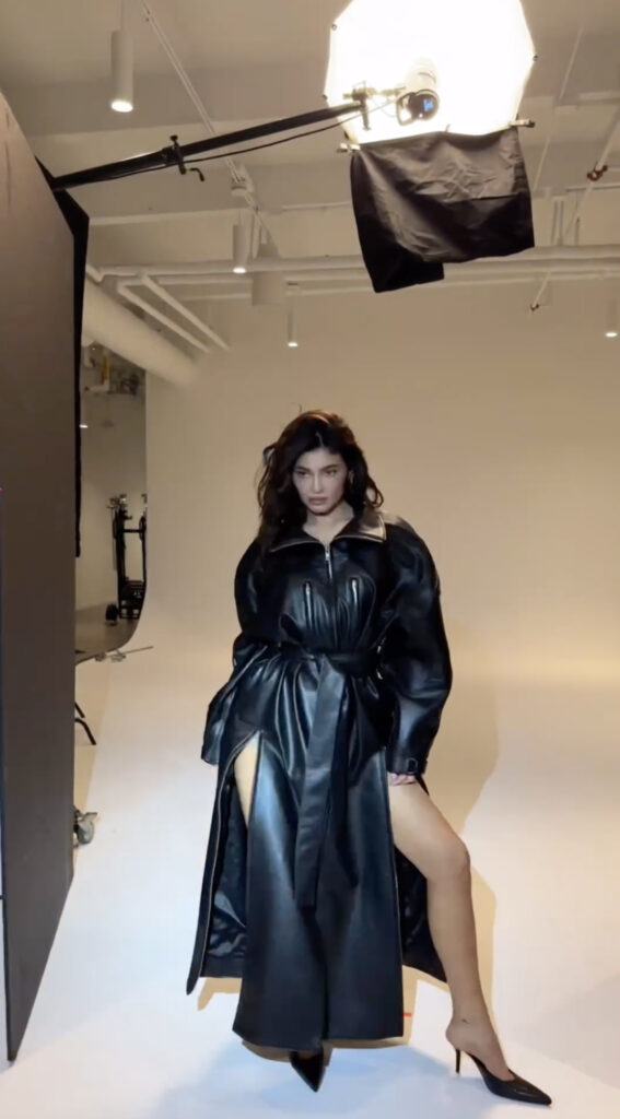 Kylie Jenner revealed her pin-thin legs under just a black leather trench coat for a new Khy ad after fans slammed the clothing brand