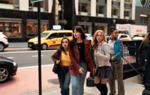 Isabela Merced, Sydney Sweeney, Celeste O’Connor, and Dakota Johnson stand in front of a subway station in Madame Web