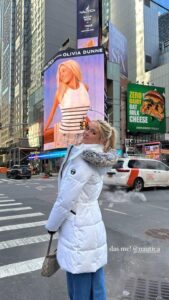 Olivia Dunne posing near her Times Square billboard.