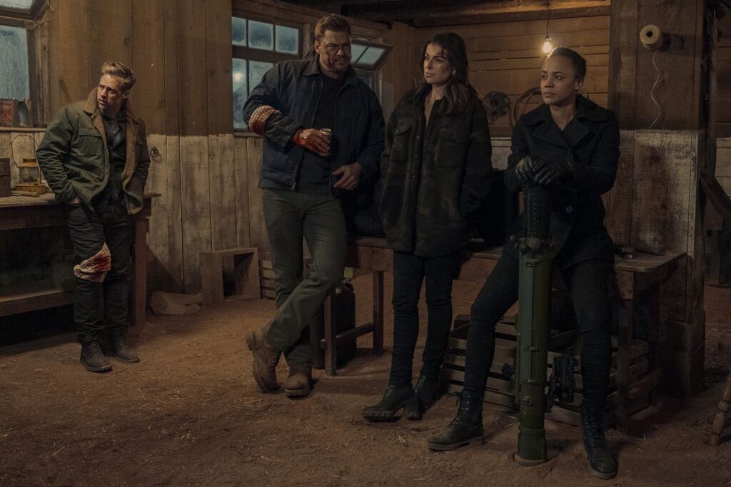 Reacher’s team of bloodied Special Investigators tired in a barn in a scene from Reacher season 2