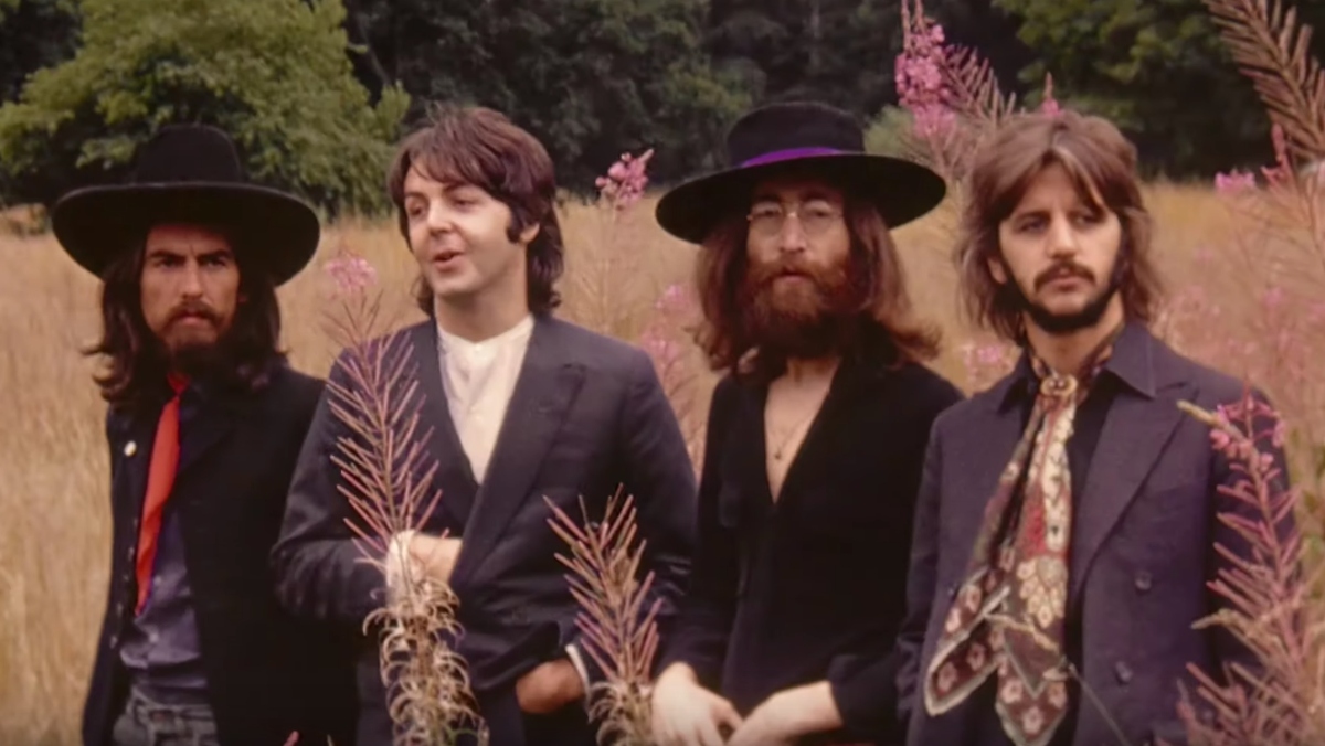 The Beatles outside in a wheat field