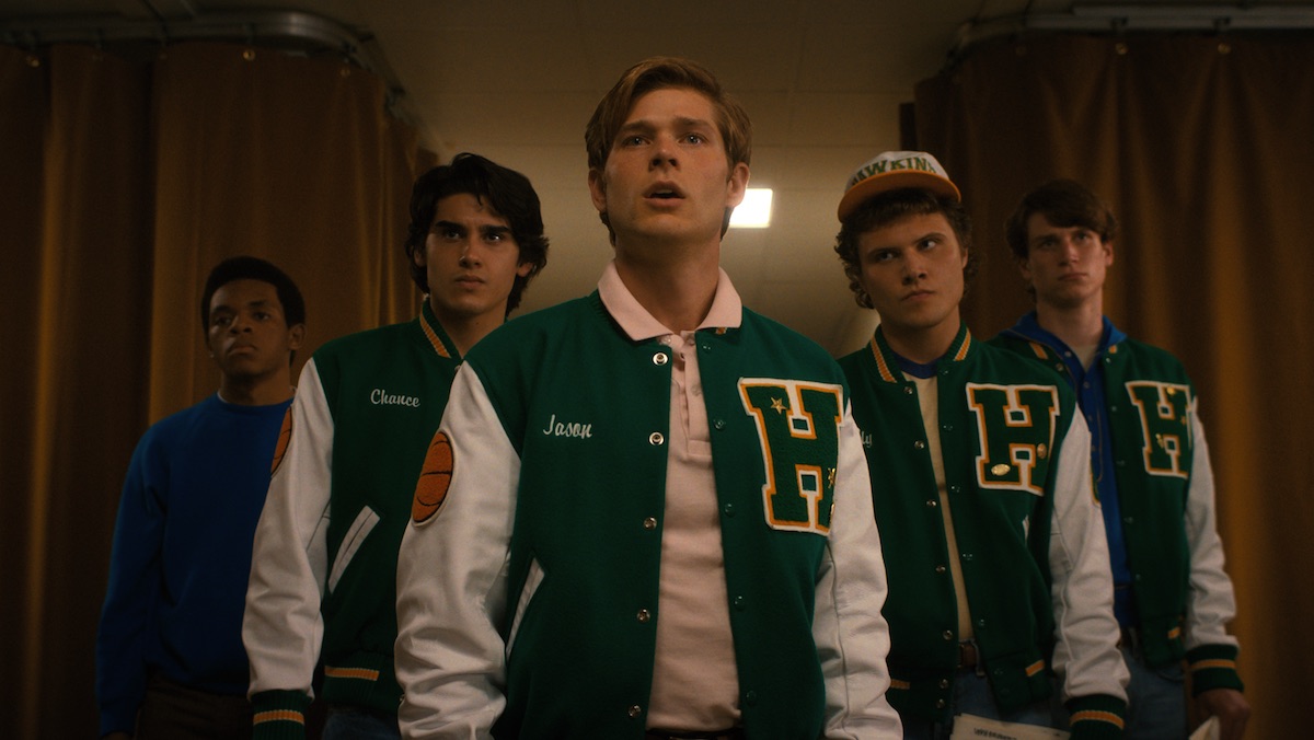 Jason leads his basketball teammates into an auditorium on Stranger Things 4