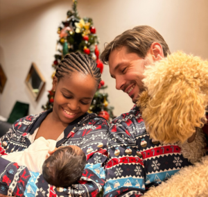 Oti shared her first photo with her newborn, as well as her husband and their dog, on Christmas Day 2023