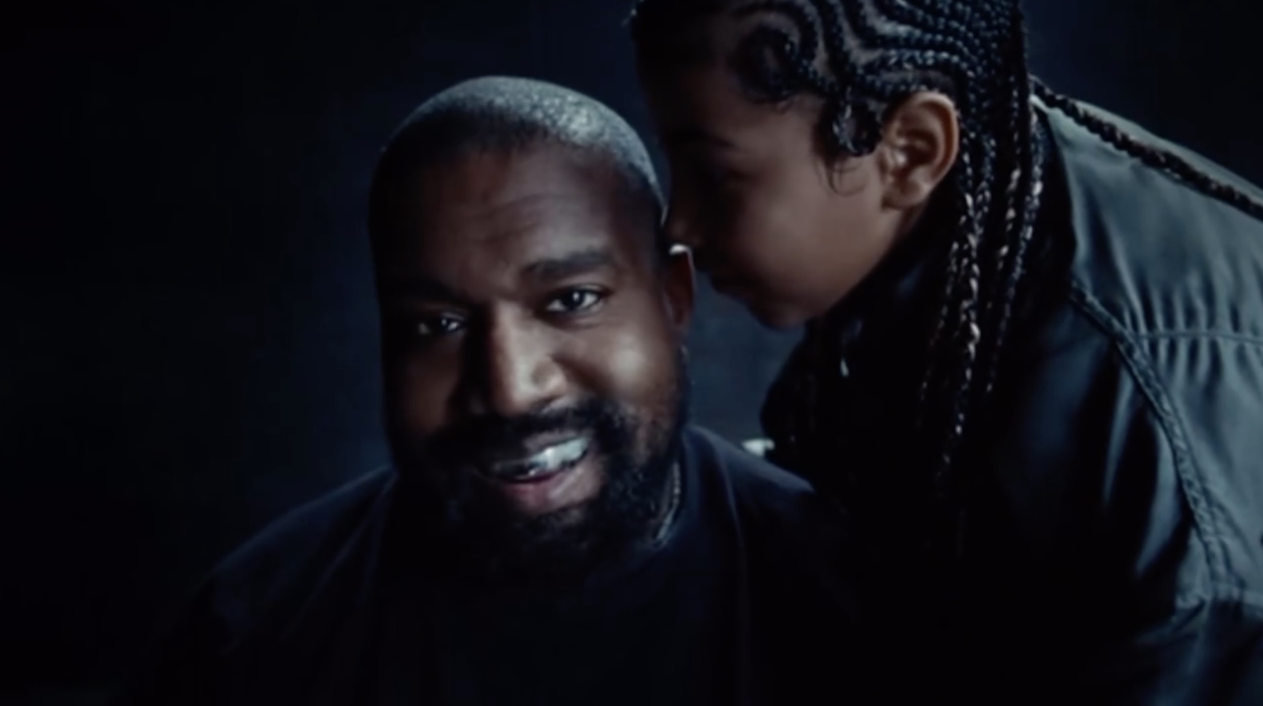 In several shots, North whispered in her dad Kanye's ear as he flashed his new titanium smile