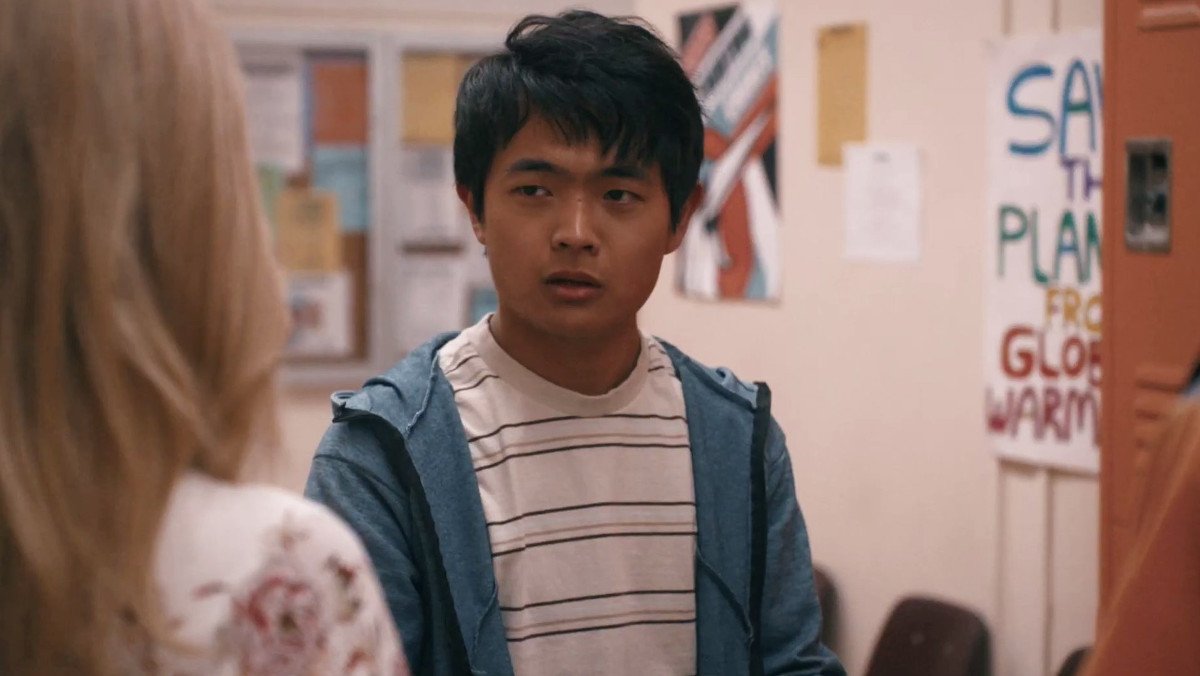 Ben Wang, the next Karate Kid, wearing a striped shirt and hoodie as Jin Wang in American Born Chinese
