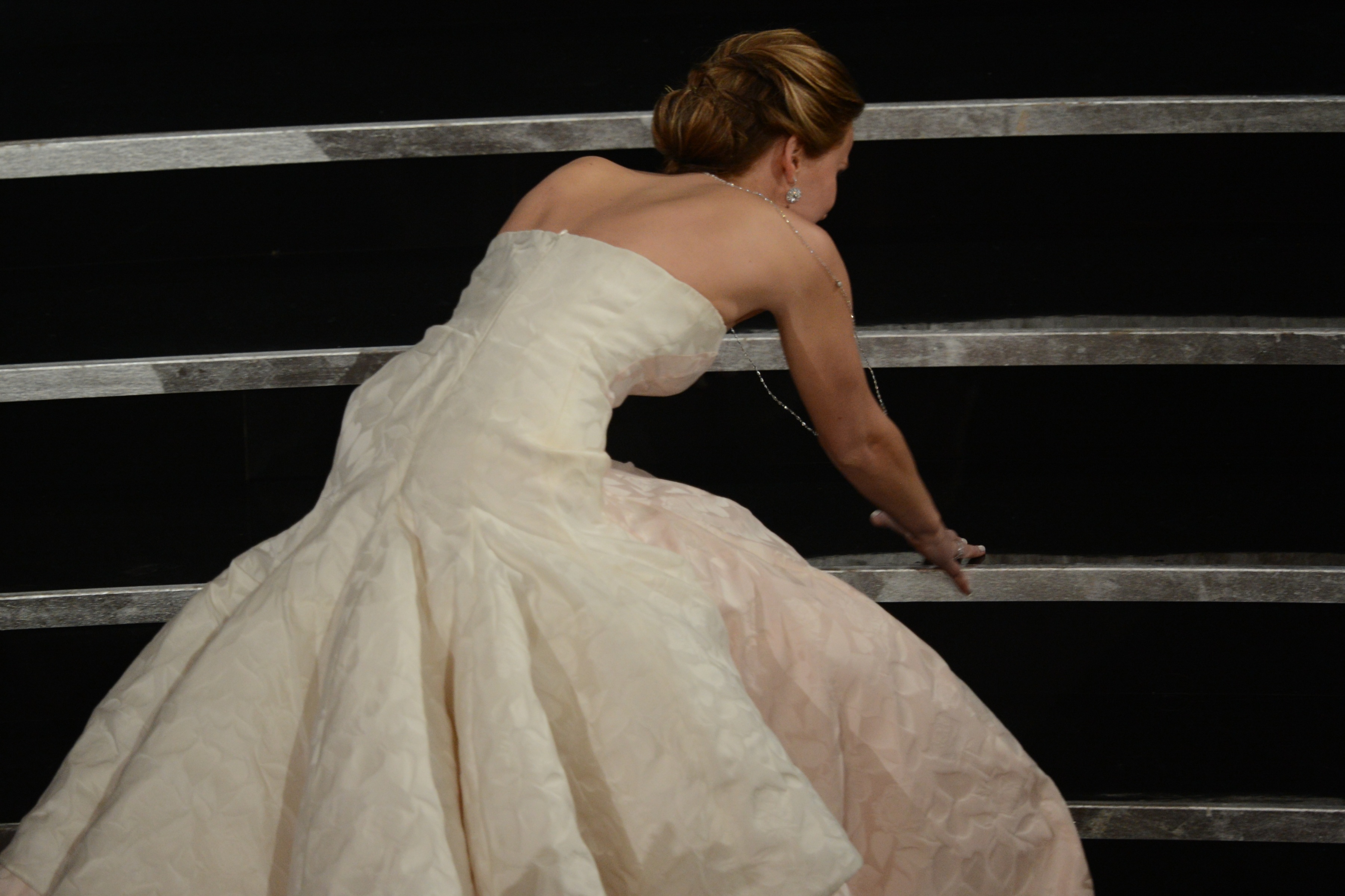 Best Actress winner Jennifer Lawrence falls onstage at the 85th Annual Oscars