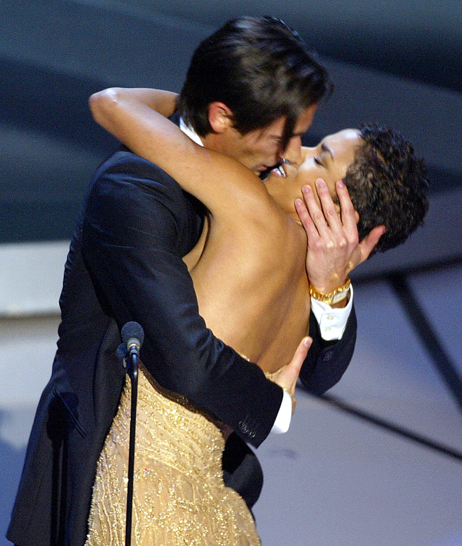 Actor Adrien Brody kisses presenter Halle Berry as he accepts his Oscar in 2003