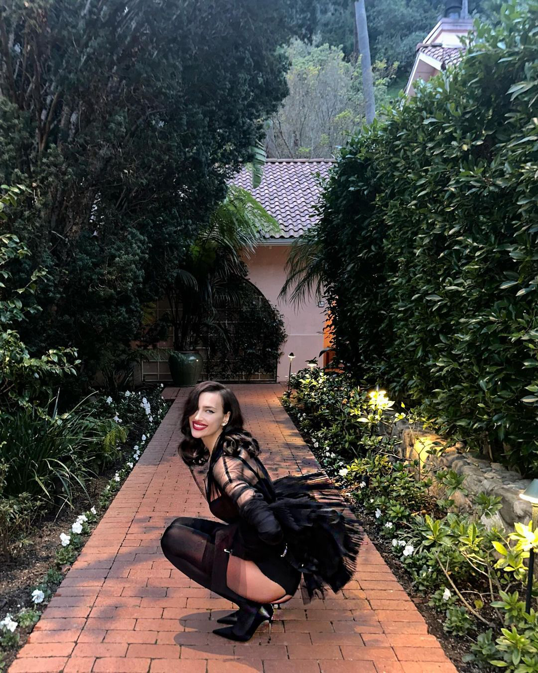 Shayk showed off her physique while wearing an all-black outfit which included stockings
