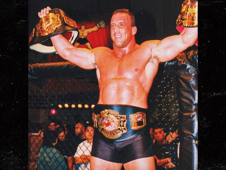 mark coleman with championship belts