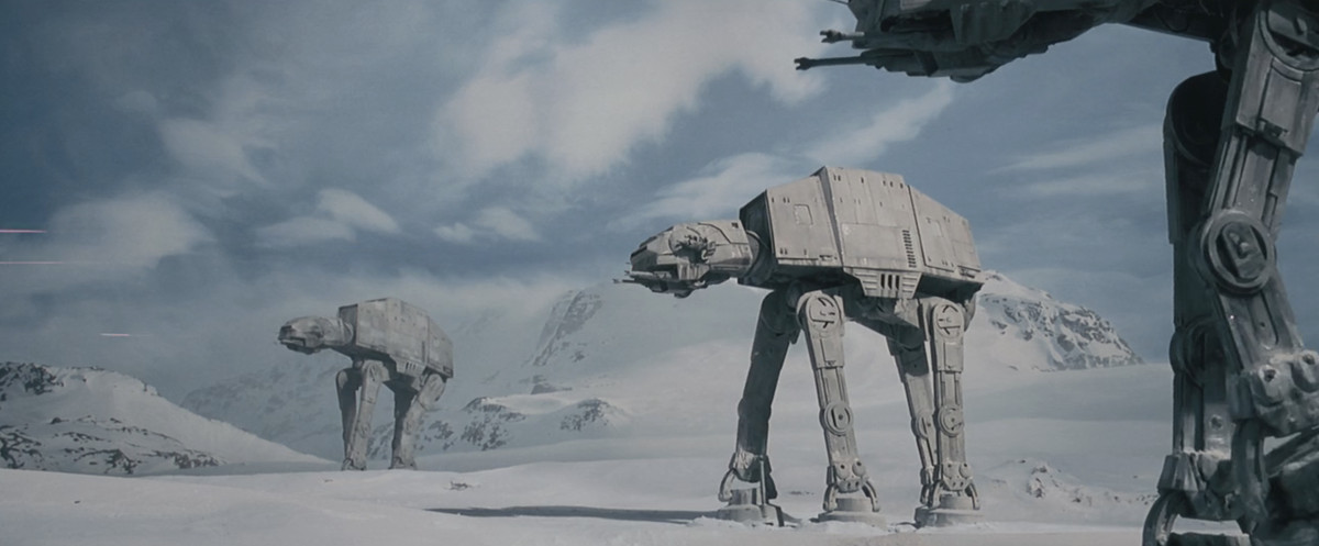 AT-AT seige walkers march across the snowy plains of the planet Hoth