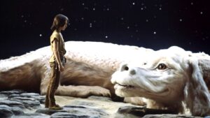 Bastian Balthazar Bux looks at the white Falkor on the ground in The Neverending Story