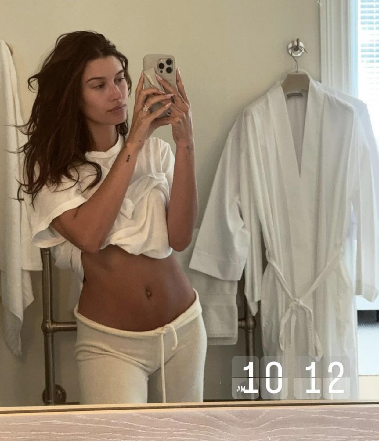 Fans noticed that the star seemed 'bloated' and that her belly button was 'sticking out' as she pulled up her top in a mirror selfie