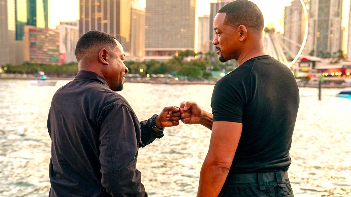 Marin Lawrence and Will Smith fist bump near a pier with Miami's syline behind them in Bad Boys: Ride or Die
