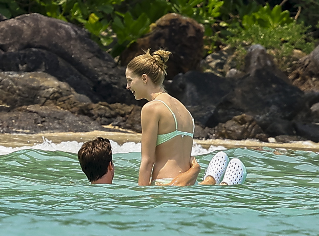 The couple were seen lying on beach chairs, walking along the shore, and floating in the ocean as relaxed on Patrick's day off