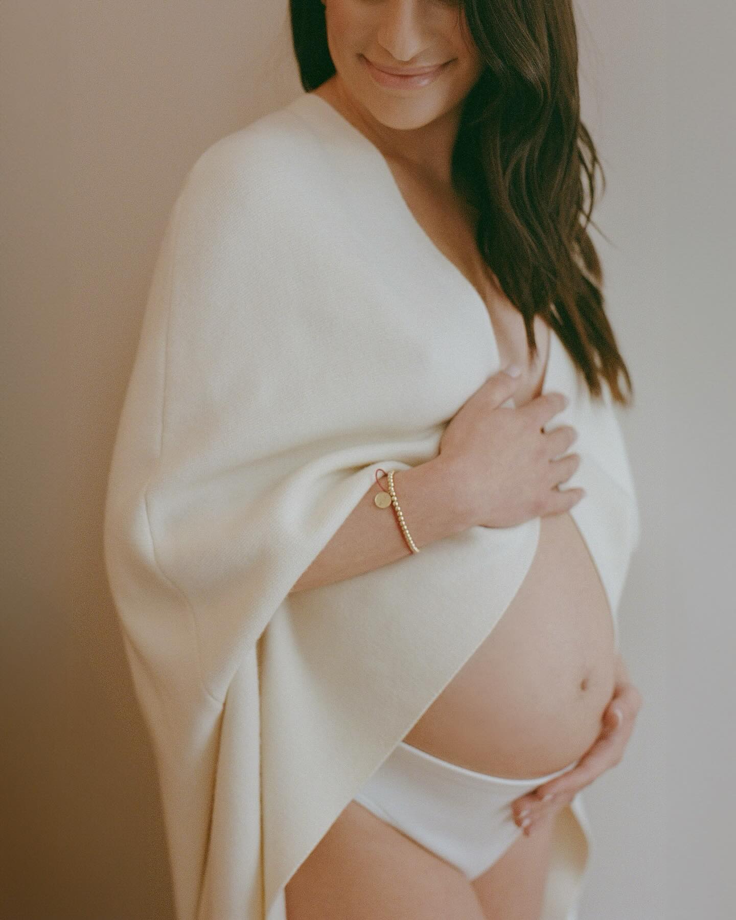 In the post, Lea shared a trio of photos holding her pregnant belly with a caption that read, 'Mommy, Daddy and Ever are overjoyed'