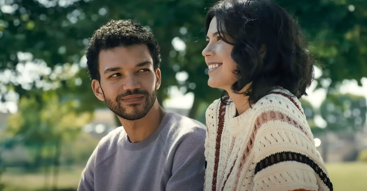 A man smiling next to a smiling woman.