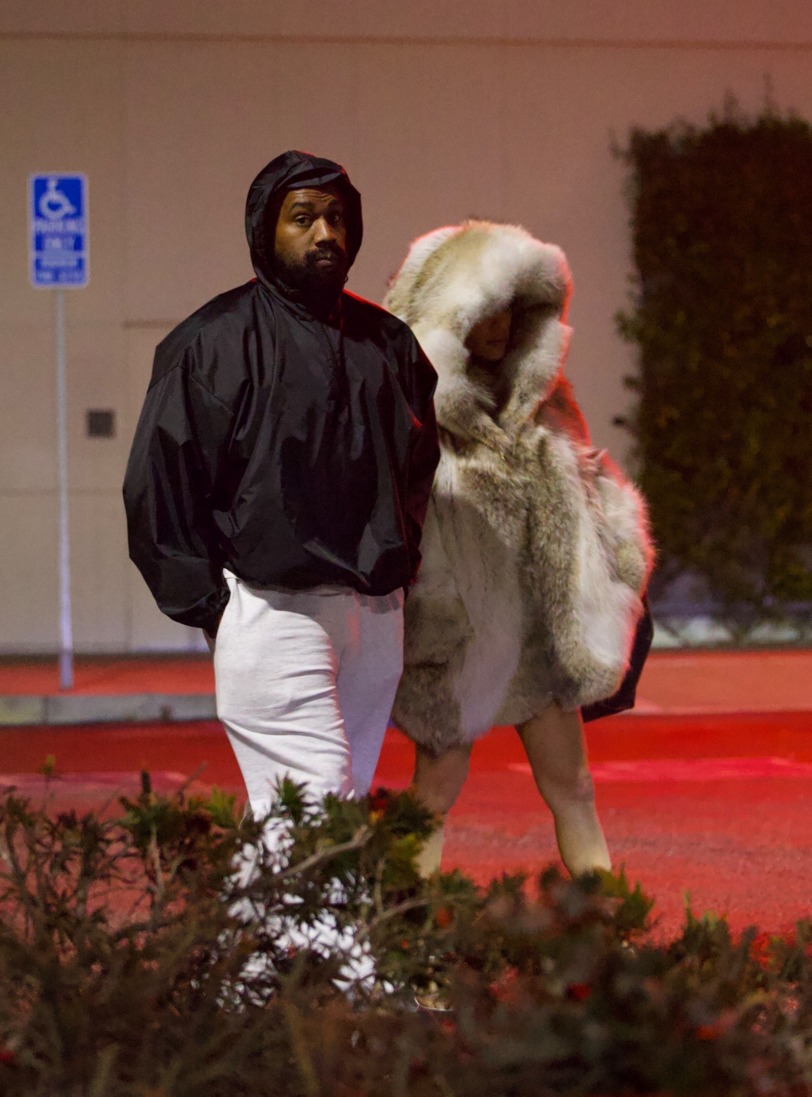 Kanye kept it casual as he sported a black windbreaker jacket and white sweatpants for the couple's evening out