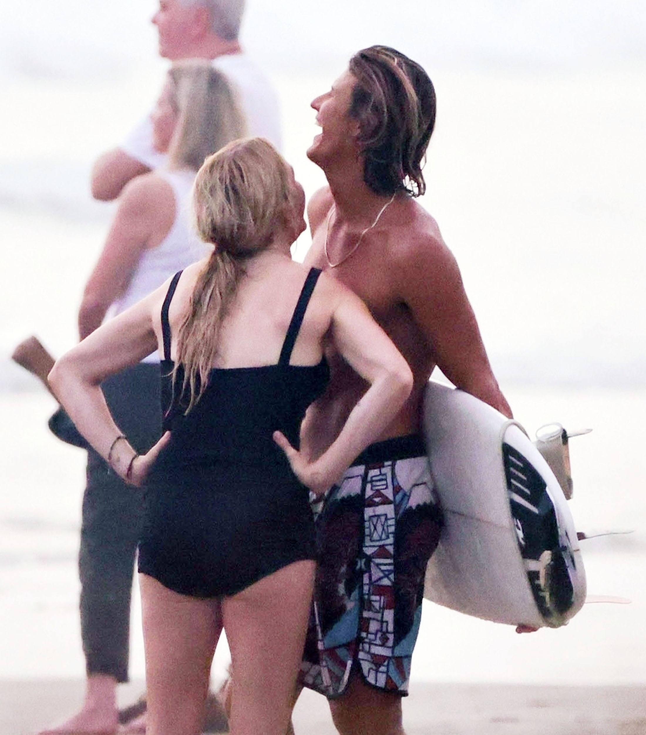 Ellie donned a black swimsuit for their sweet beach date