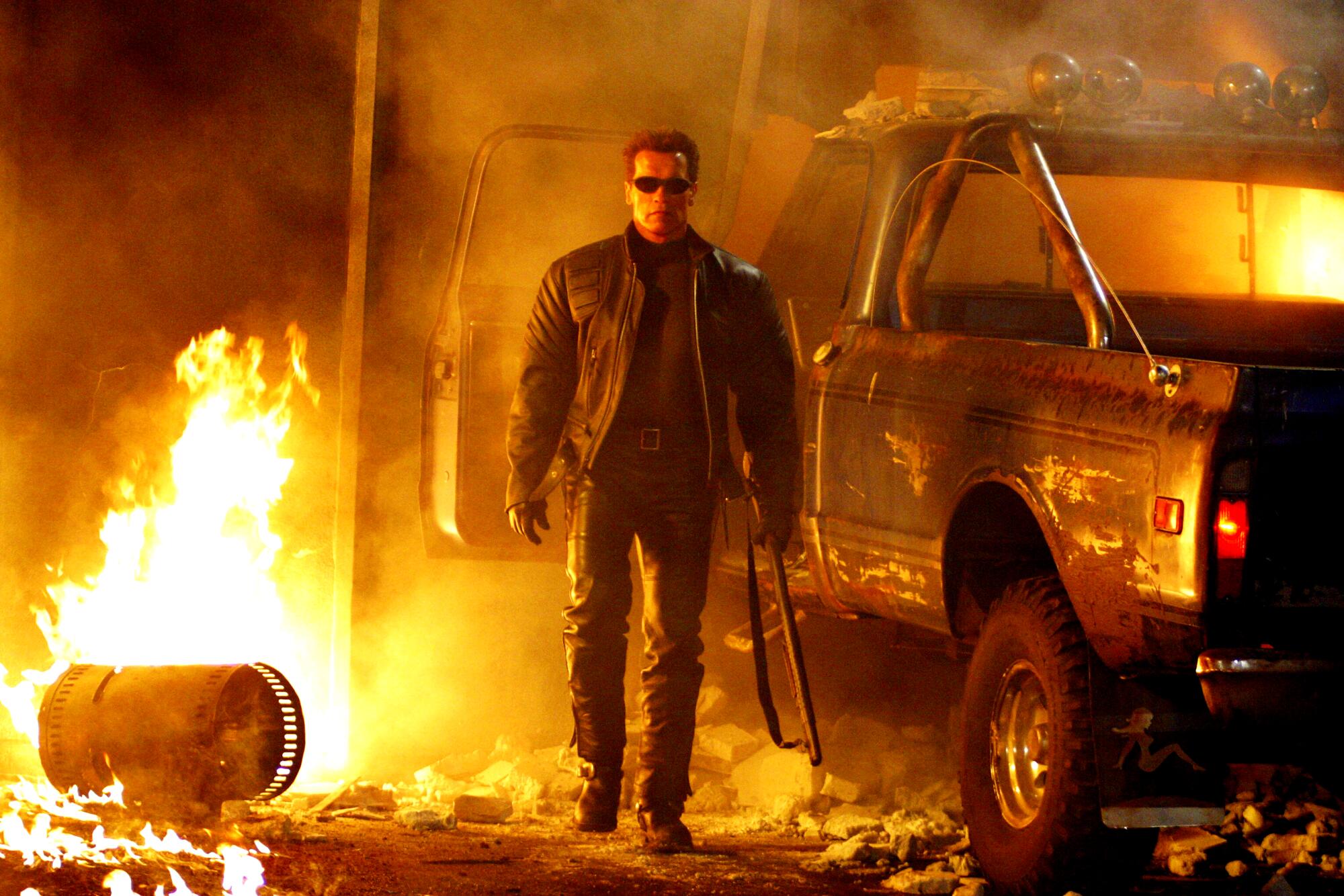 Arnold Schwarzenegger as the Terminator surrounded by fire 