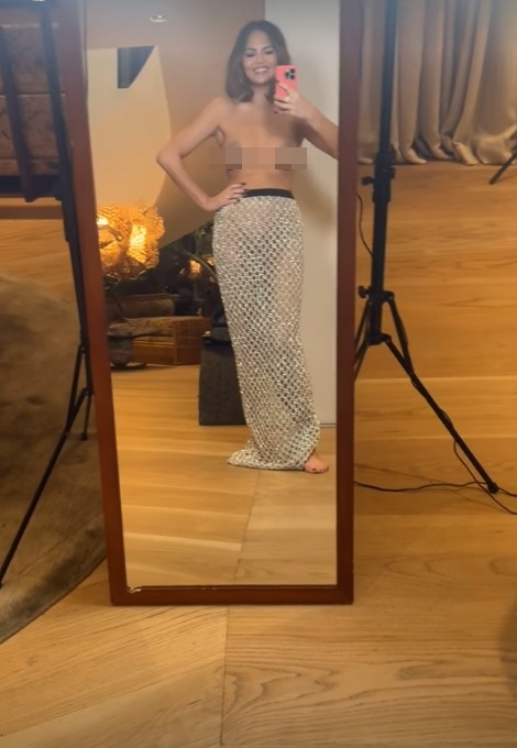 Chrissy Teigen went topless while wearing only nipple covers to show off her see-through skirt in a new selfie video