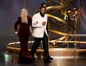 Christina Applegate is escorted by host Anthony Anderson as she walks onstage at 75th Primetime Emmy Awards on Jan. 15 in Los Angeles.