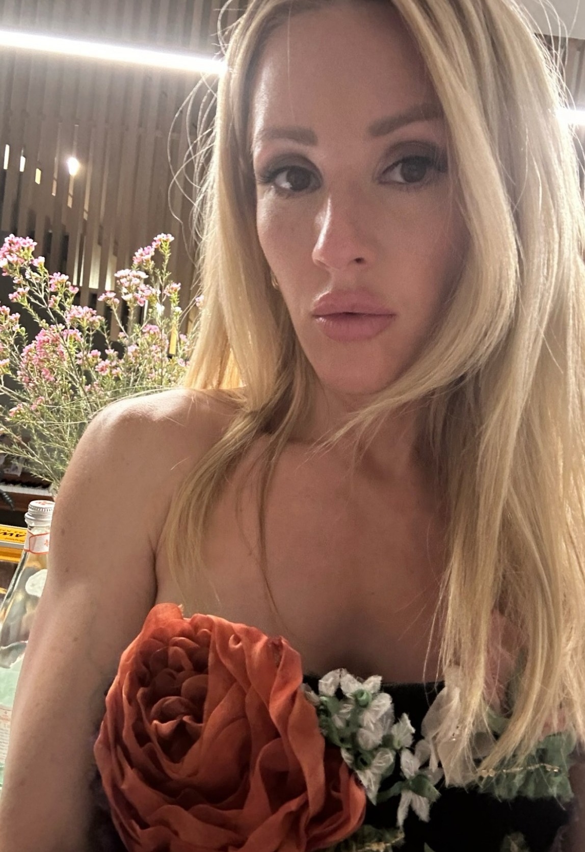 Ellie dressed in a glamorous floral dress in the evening