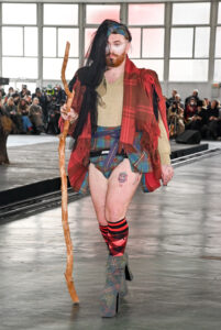 Sam Smith walked in a colour clash of tartan for the Paris Fashion Week runway