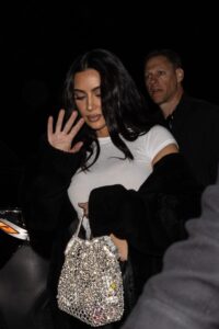 Photos captured Kim Kardashian shielding her face from cameras while attending her ex-husband Kanye West's concert